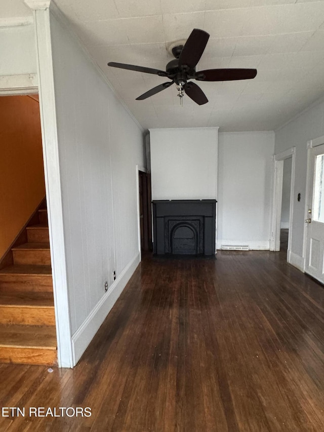 unfurnished living room featuring dark hardwood / wood-style flooring, a baseboard radiator, and ceiling fan