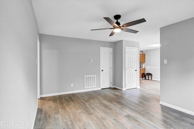 unfurnished room with hardwood / wood-style floors and ceiling fan