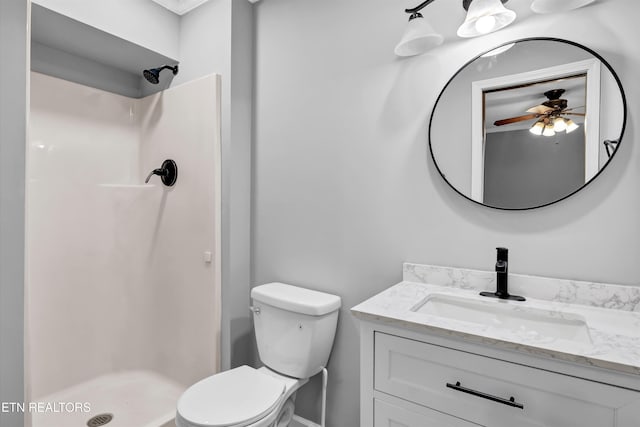 bathroom with walk in shower, ceiling fan, vanity, and toilet