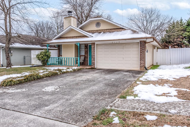 view of front of property featuring covered porch and a garage