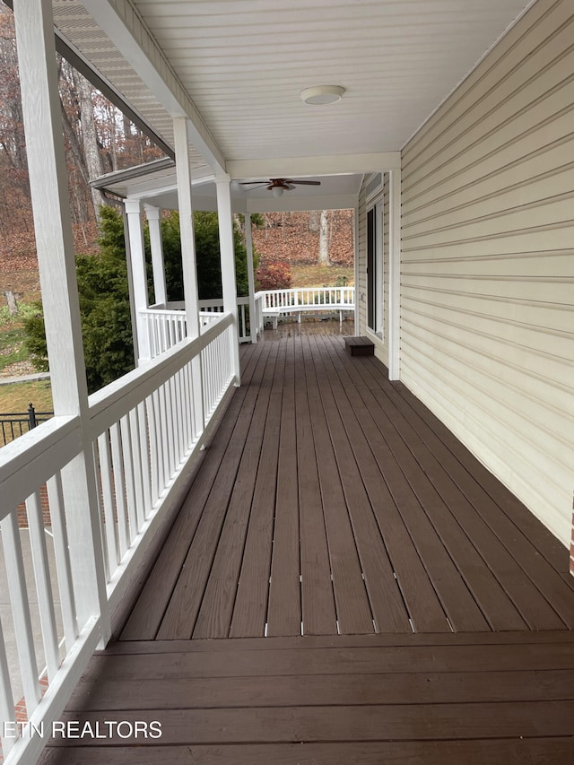 wooden terrace featuring ceiling fan and a porch