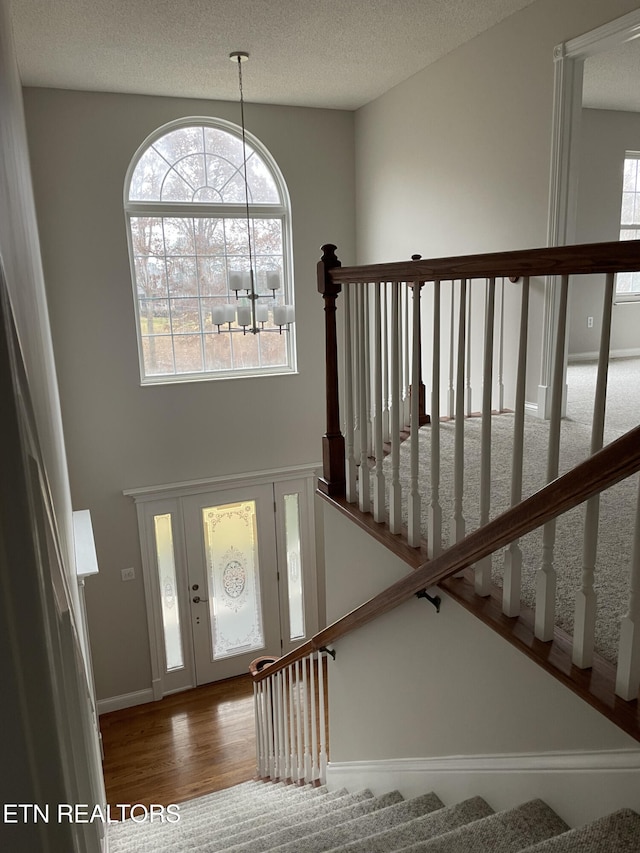 foyer entrance featuring hardwood / wood-style floors and a textured ceiling