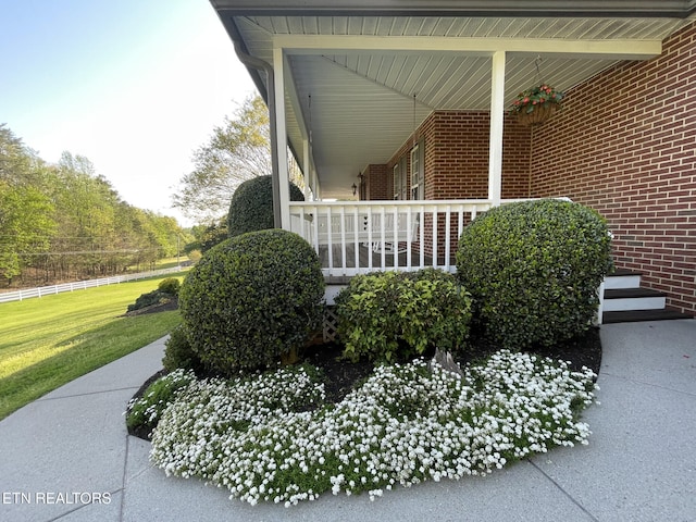 view of property exterior with a lawn and brick siding