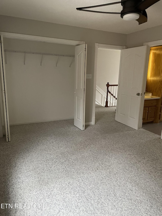 unfurnished bedroom with ceiling fan and a closet