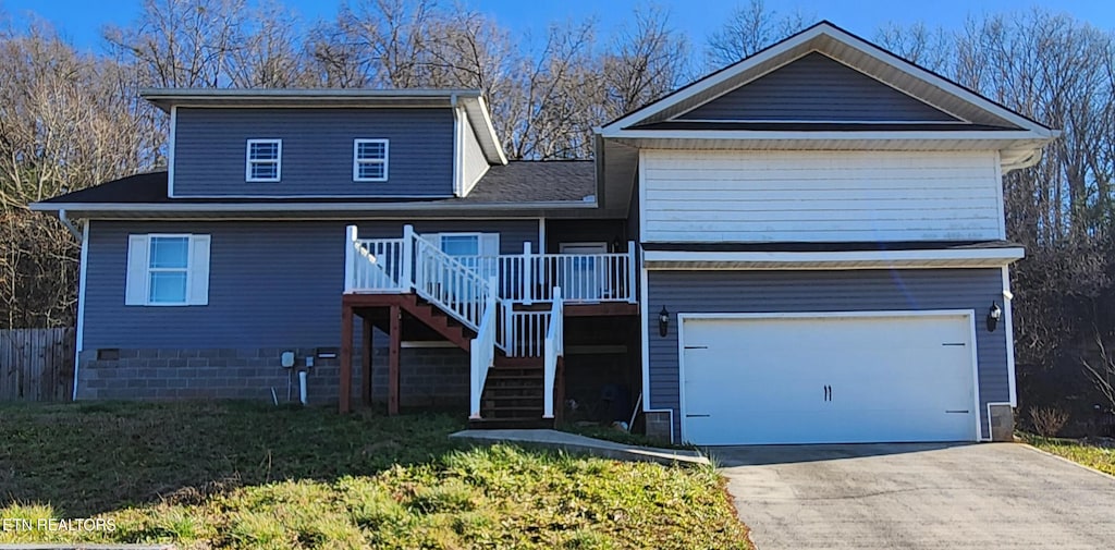 front of property featuring a front yard and a garage