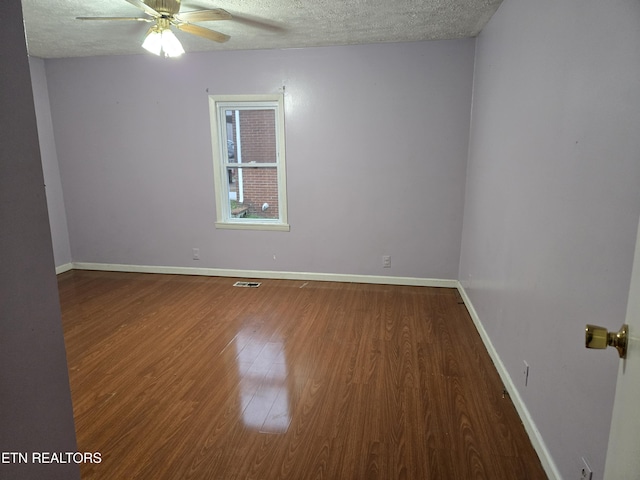 empty room featuring hardwood / wood-style floors, a textured ceiling, and ceiling fan