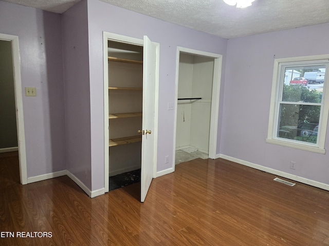 unfurnished bedroom featuring wood-type flooring and a textured ceiling