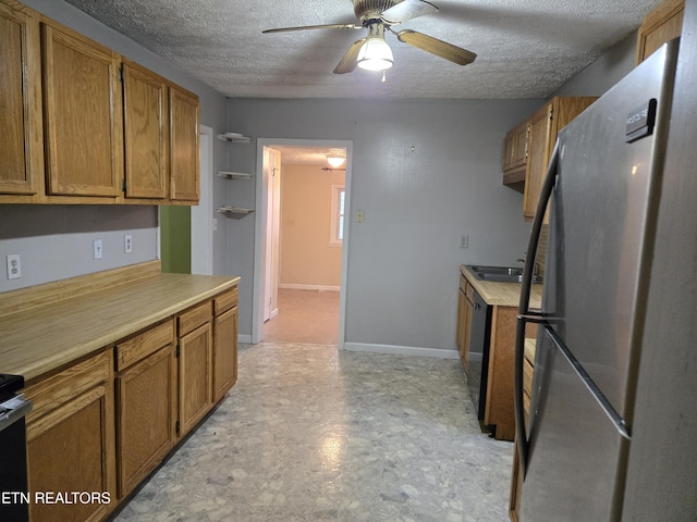 kitchen featuring stainless steel fridge, a textured ceiling, and ceiling fan