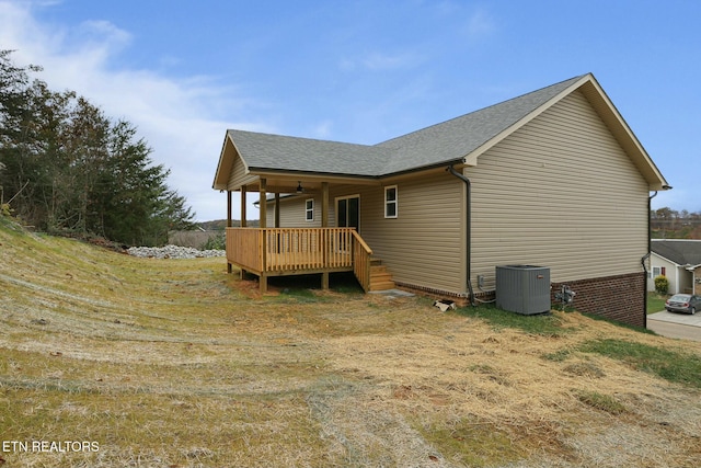 rear view of property with central AC, ceiling fan, and a deck