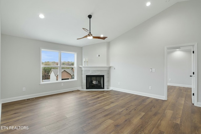 unfurnished living room featuring hardwood / wood-style floors, a fireplace, high vaulted ceiling, and ceiling fan