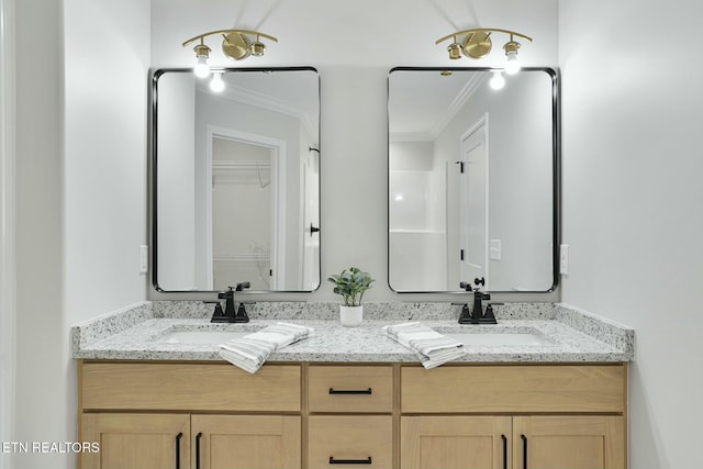 bathroom with ornamental molding and vanity