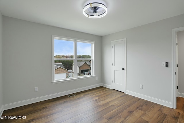 unfurnished room featuring dark hardwood / wood-style flooring