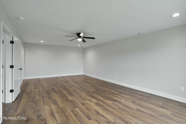 empty room featuring dark wood-type flooring and ceiling fan