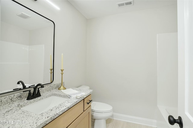 bathroom featuring vanity and toilet