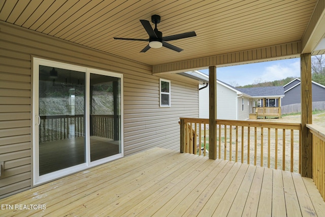 wooden deck featuring ceiling fan