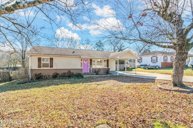 ranch-style home featuring a carport and a front lawn