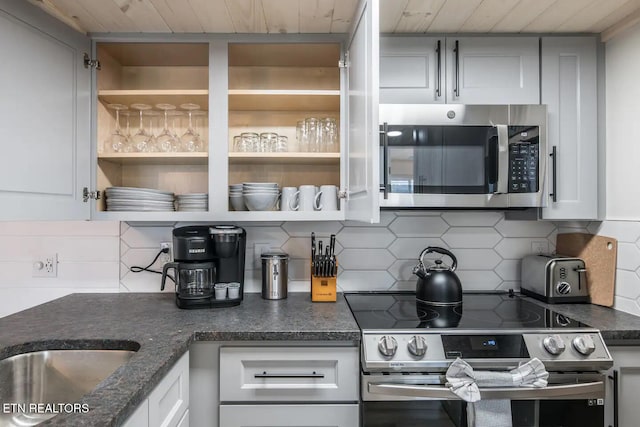 kitchen featuring white cabinets, tasteful backsplash, stainless steel appliances, and wooden ceiling