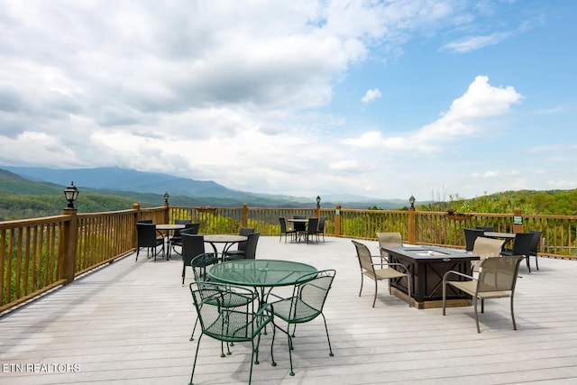 deck featuring a mountain view and an outdoor fire pit