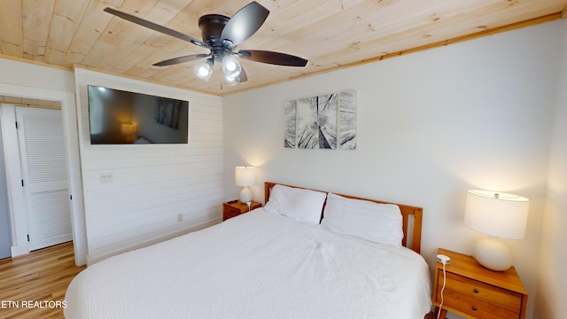 bedroom with ceiling fan, ornamental molding, wooden ceiling, and hardwood / wood-style flooring