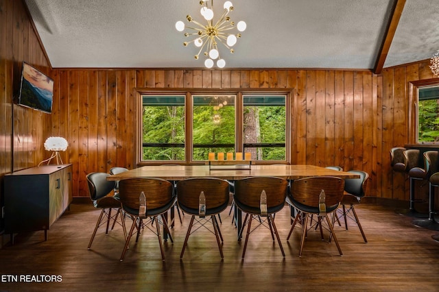 dining area with vaulted ceiling with beams, dark hardwood / wood-style floors, and an inviting chandelier