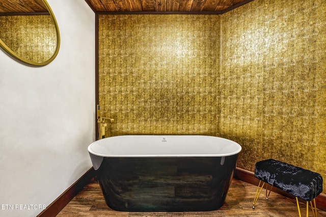 bathroom featuring hardwood / wood-style floors, a bathtub, and wood ceiling