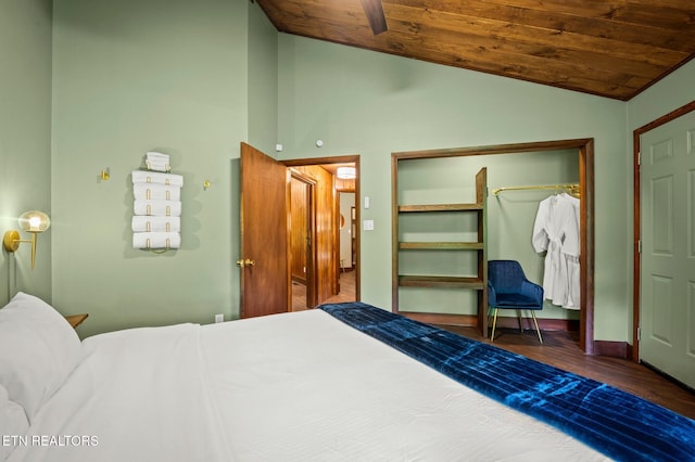 bedroom with dark wood-type flooring, vaulted ceiling, a closet, and wooden ceiling