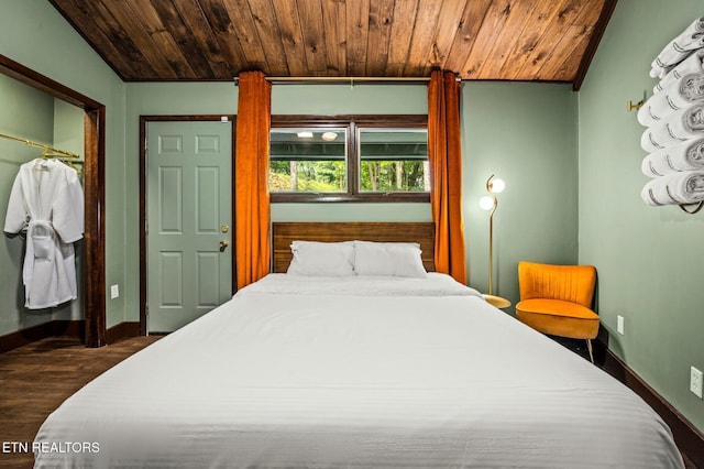 bedroom with wood ceiling, dark wood-type flooring, and lofted ceiling