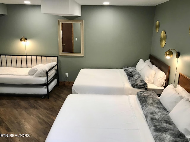 bedroom with dark hardwood / wood-style floors