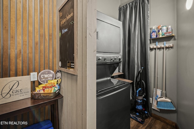 interior space with dark hardwood / wood-style flooring and stacked washer and clothes dryer