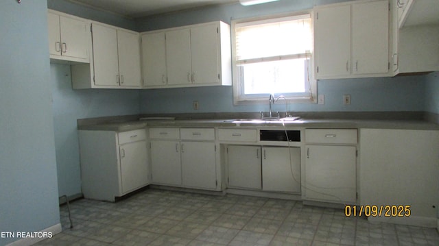 kitchen featuring sink and white cabinets