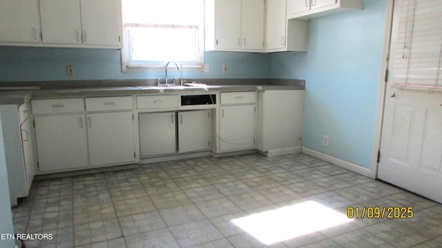 kitchen with white cabinetry and sink