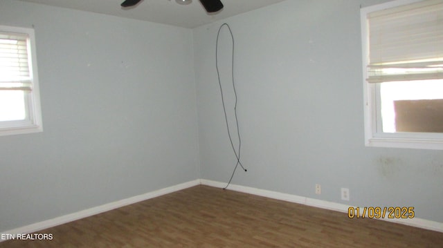 empty room with hardwood / wood-style floors and ceiling fan