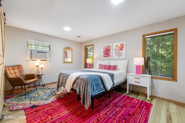 bedroom featuring hardwood / wood-style floors and cooling unit