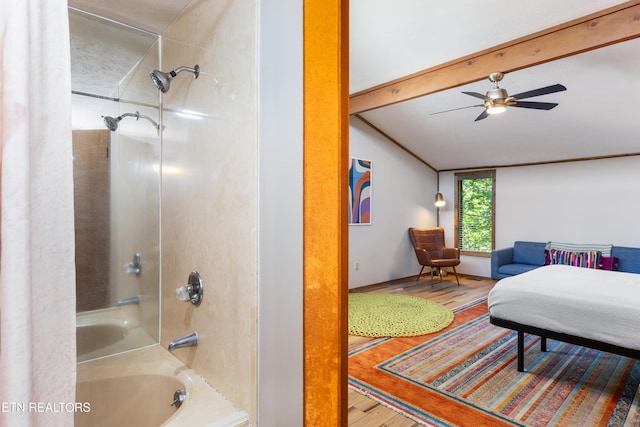 bathroom with hardwood / wood-style floors, lofted ceiling with beams, shower / bathtub combination, and ceiling fan