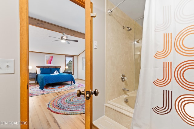 bathroom featuring ceiling fan, beamed ceiling, shower / tub combo, and hardwood / wood-style flooring