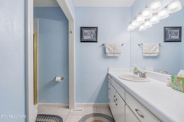 bathroom featuring tile patterned floors, vanity, and walk in shower