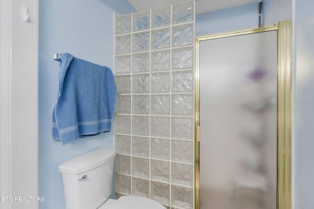 bathroom featuring toilet and walk in shower