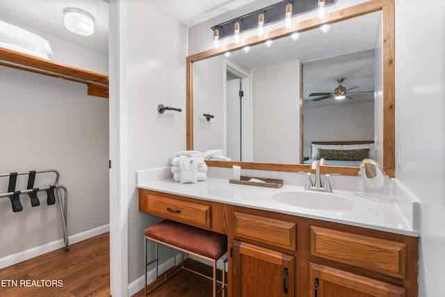 bathroom featuring hardwood / wood-style flooring, ceiling fan, a textured ceiling, and vanity