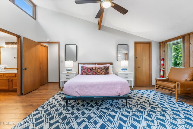 bedroom with ensuite bathroom, ceiling fan, lofted ceiling, and hardwood / wood-style flooring