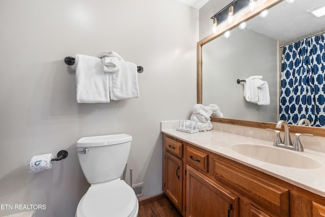 bathroom featuring vanity and toilet