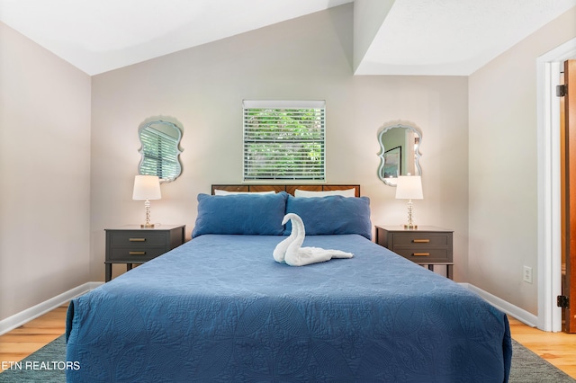 bedroom featuring lofted ceiling and light wood-type flooring