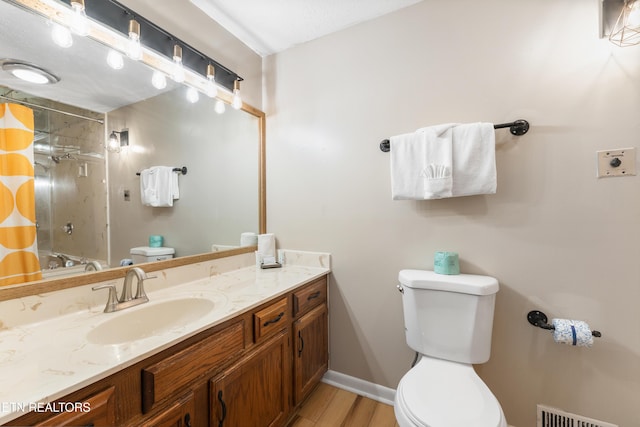 full bathroom with vanity, toilet, wood-type flooring, and washtub / shower combination