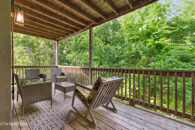 wooden terrace with an outdoor hangout area