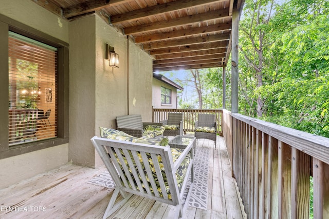 wooden terrace with outdoor lounge area