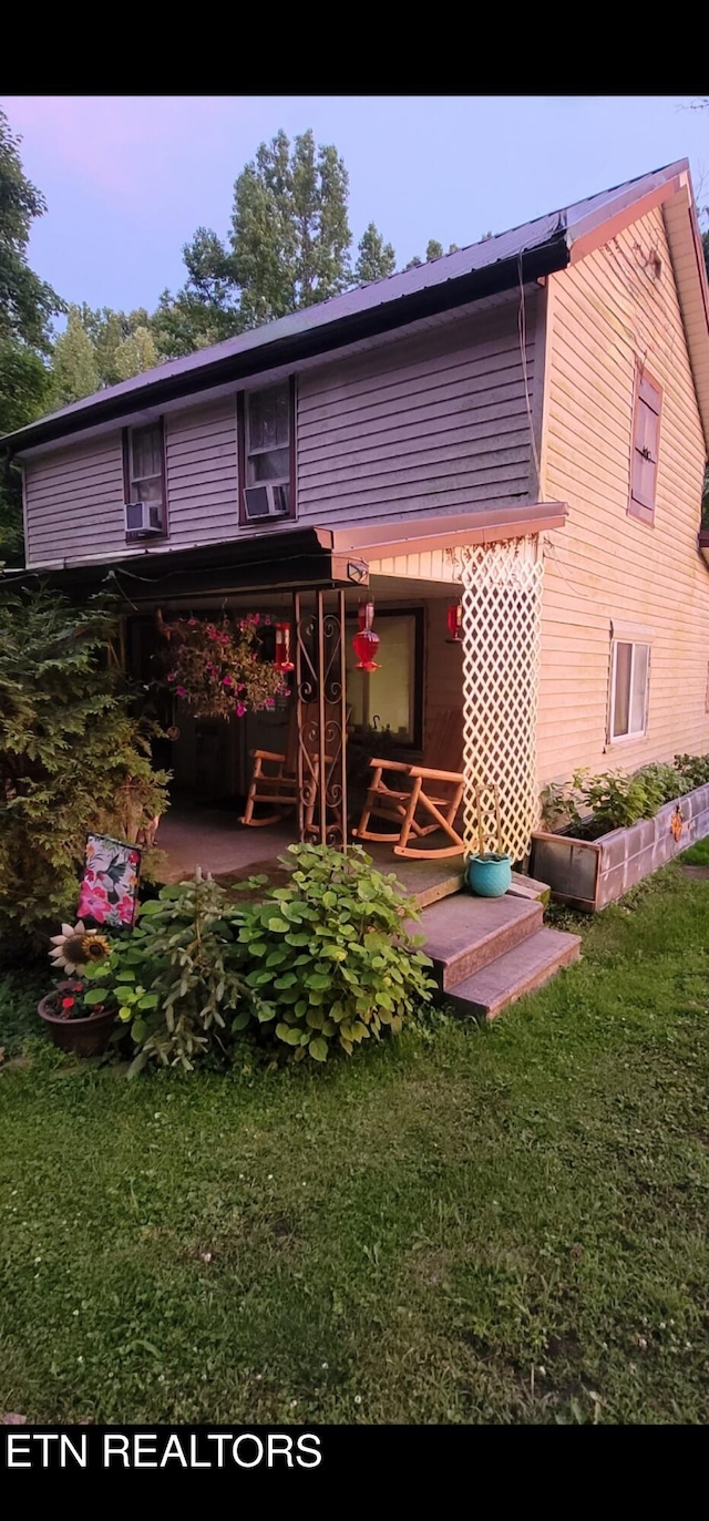 rear view of house with a yard