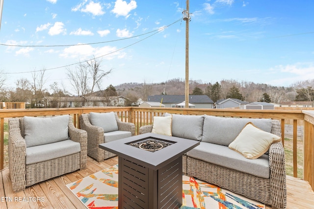 wooden deck featuring an outdoor fire pit