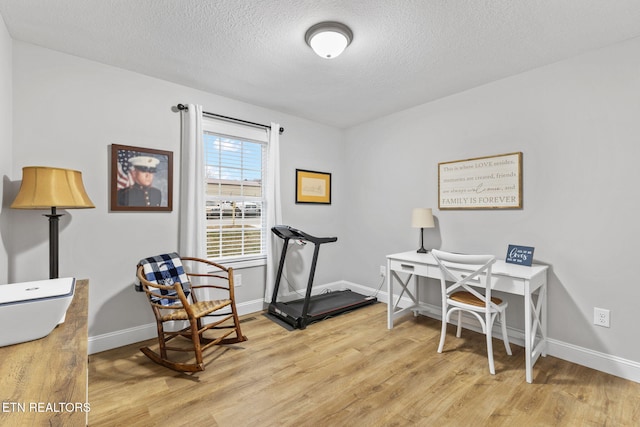 office area featuring a textured ceiling and light hardwood / wood-style floors