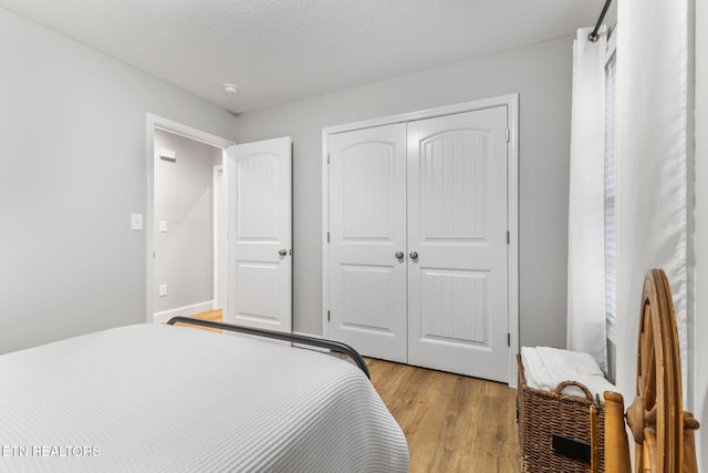 bedroom featuring a closet and light wood-type flooring