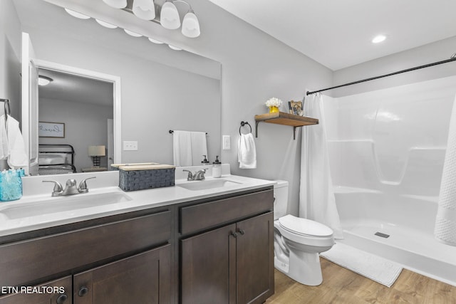 bathroom featuring a shower with curtain, vanity, toilet, and hardwood / wood-style floors