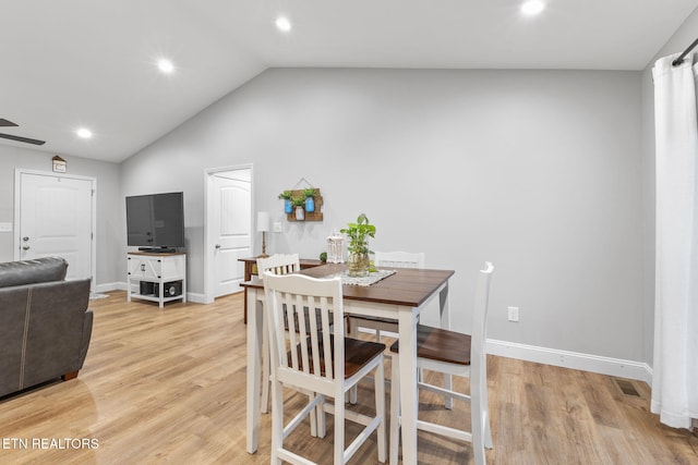 dining area featuring lofted ceiling, hardwood / wood-style floors, and ceiling fan